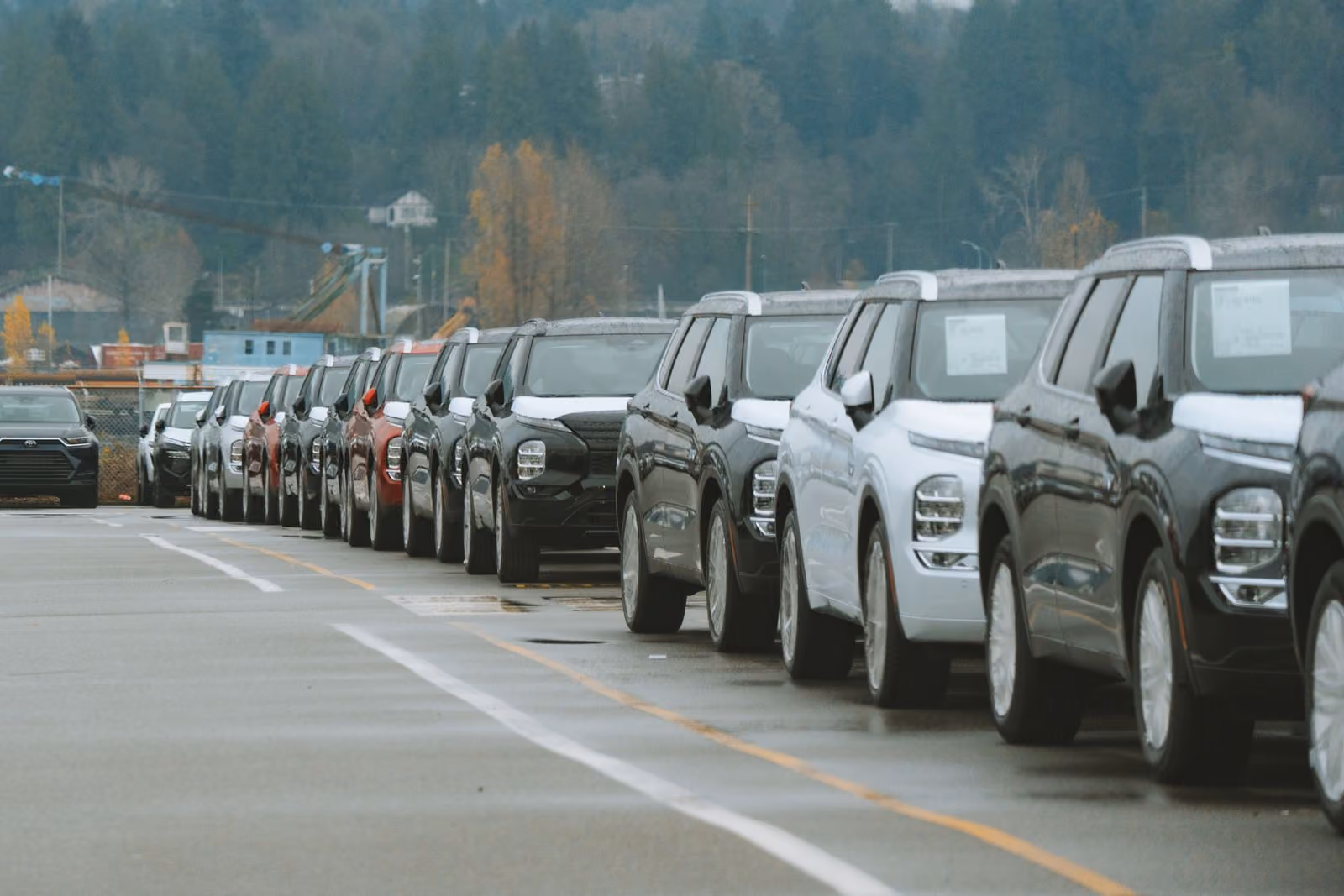 A row of vehicles staged in a dealership lot, waiting to run
